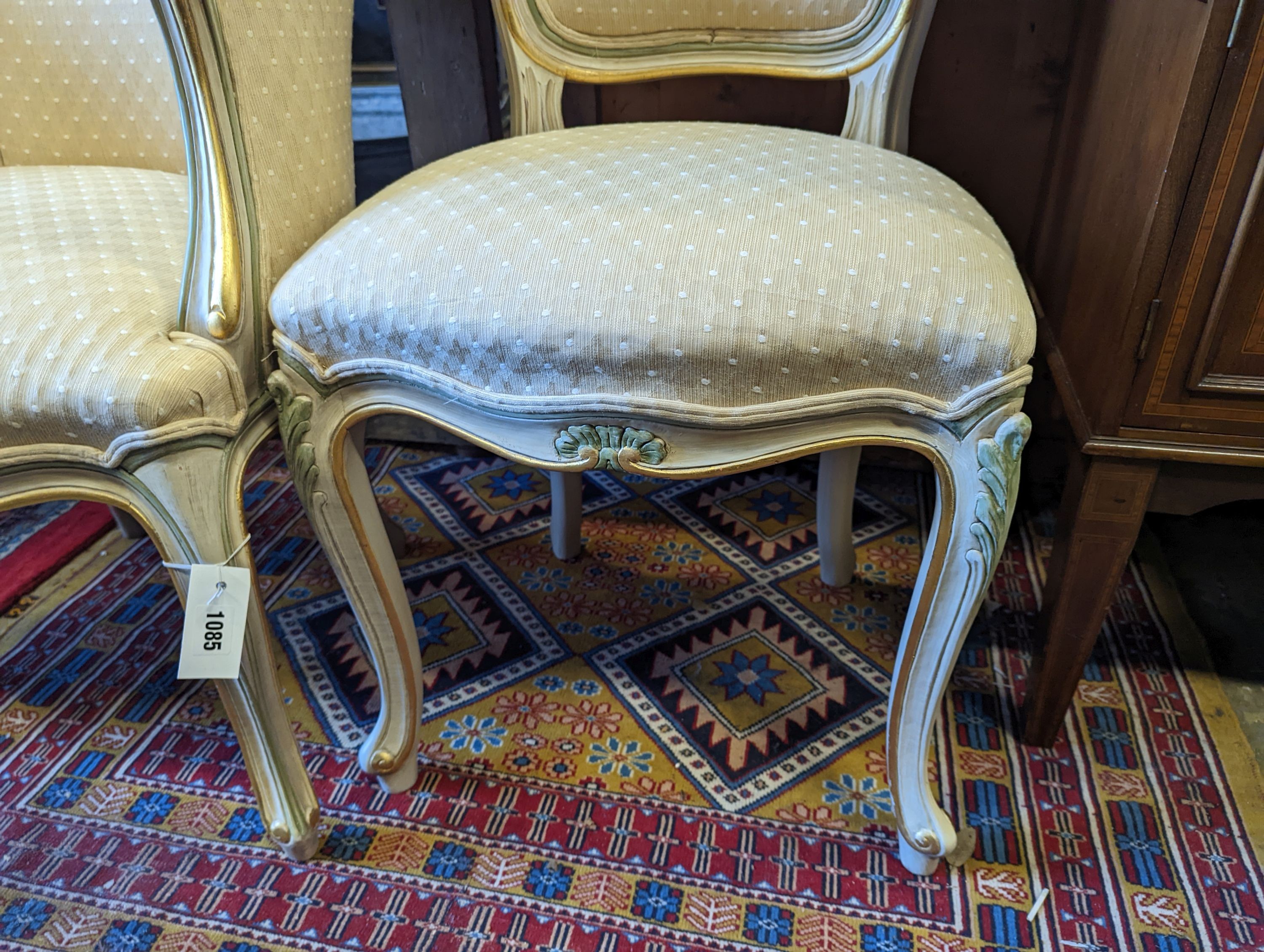 A Louis XVI style painted upholstered tub chair and a similar side chair